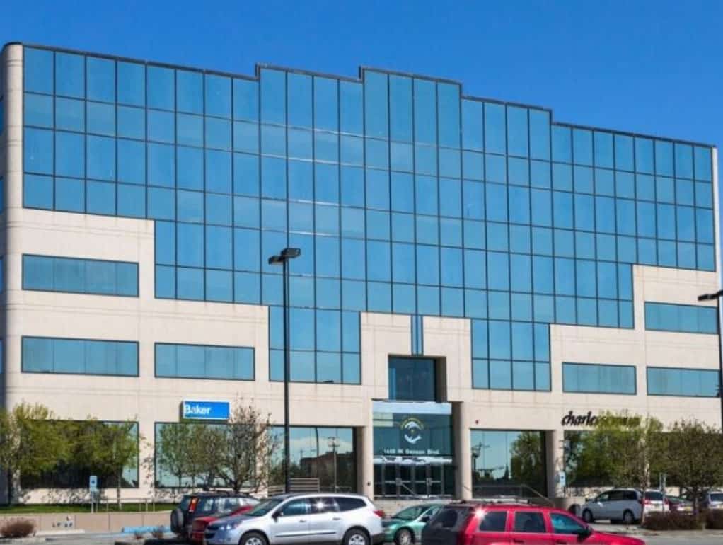 Modern office building with reflective glass windows in Alaska.